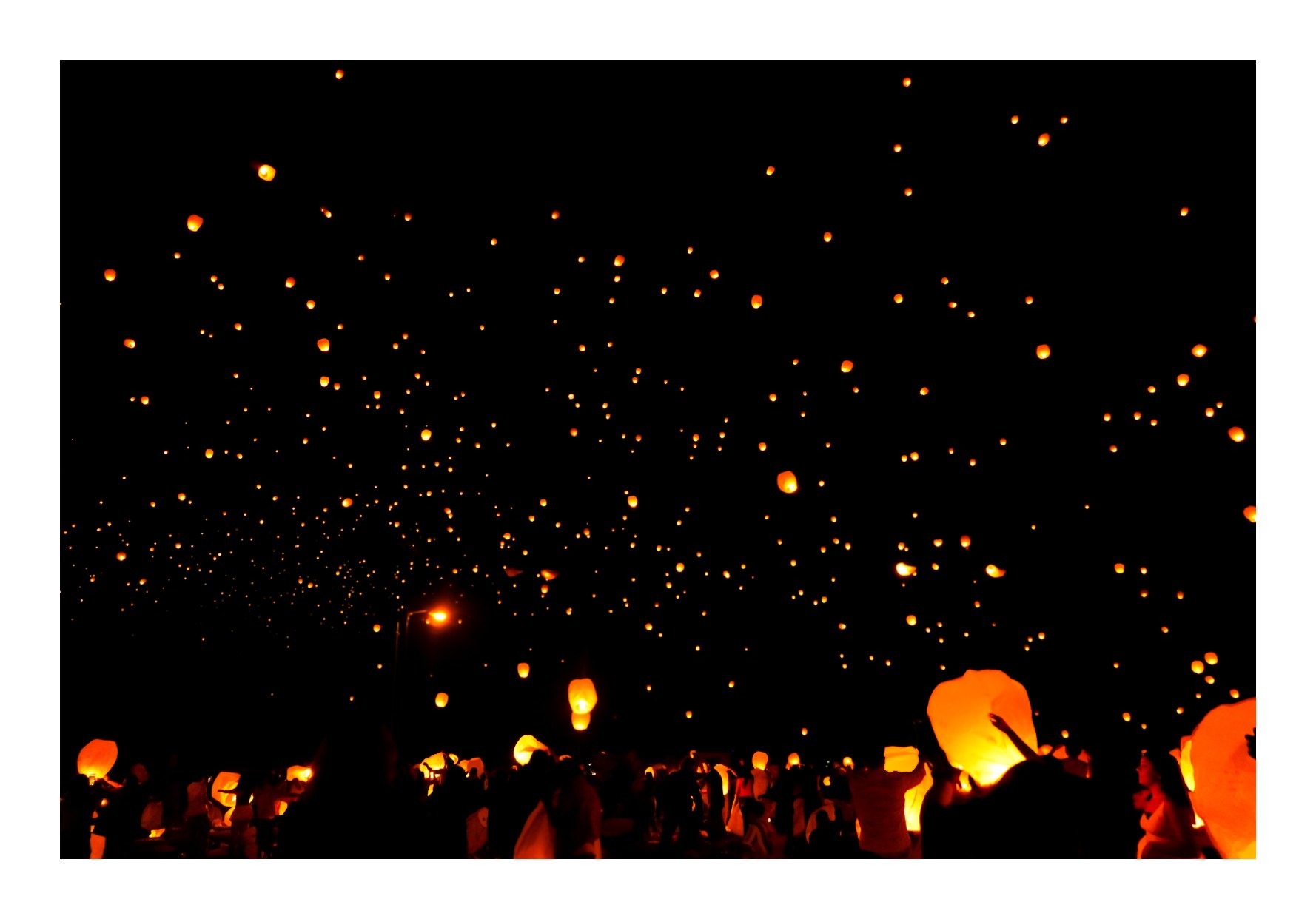 Sky lanterns rising at night